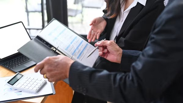 Business owner comparing employee benefits broker options in California.