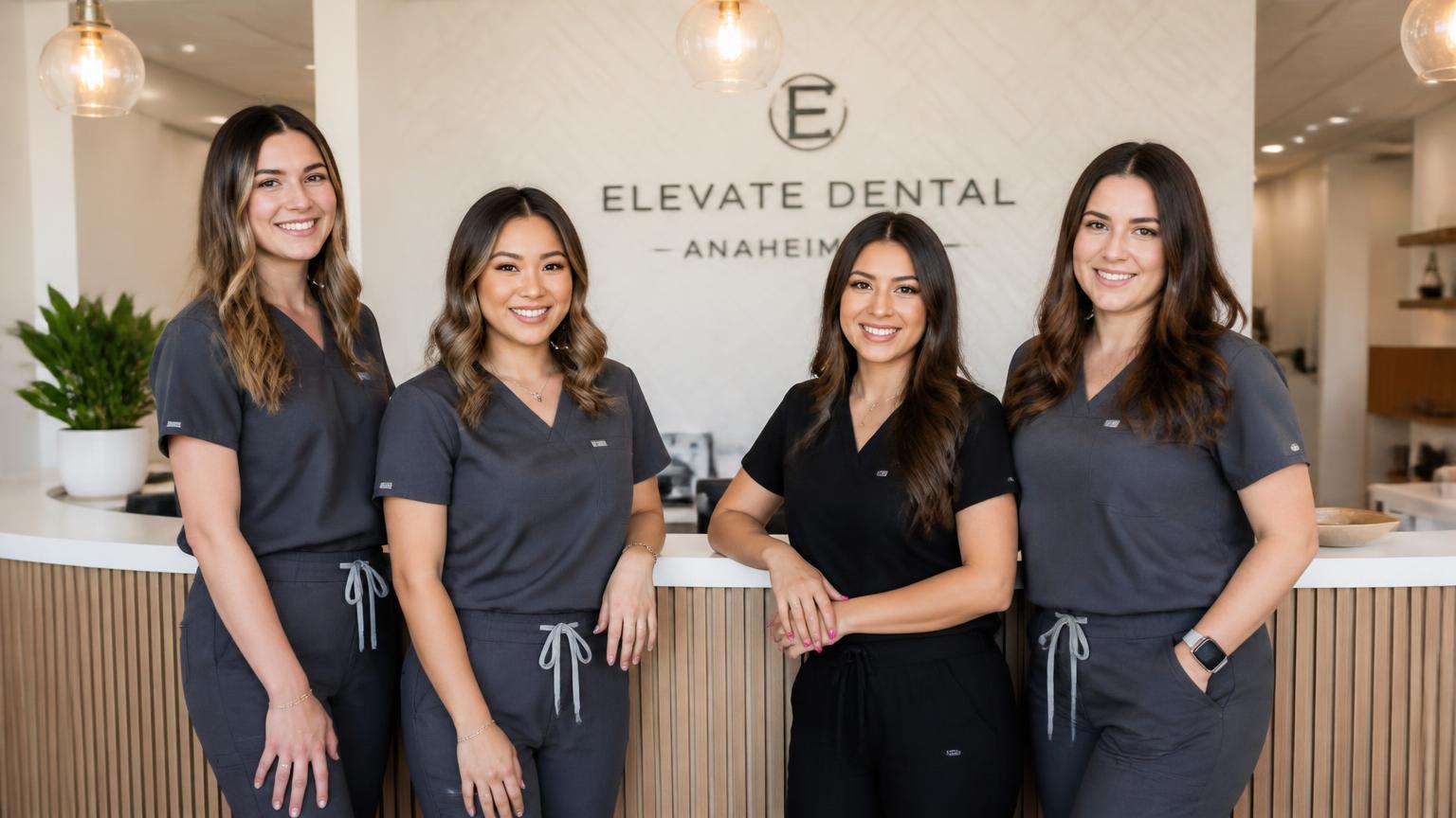 Dental practice team of hygienists and front office staff at a California clinic reception desk
