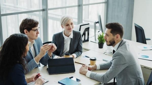 Business owners meeting with a commercial insurance broker in California to discuss insurance coverage options.